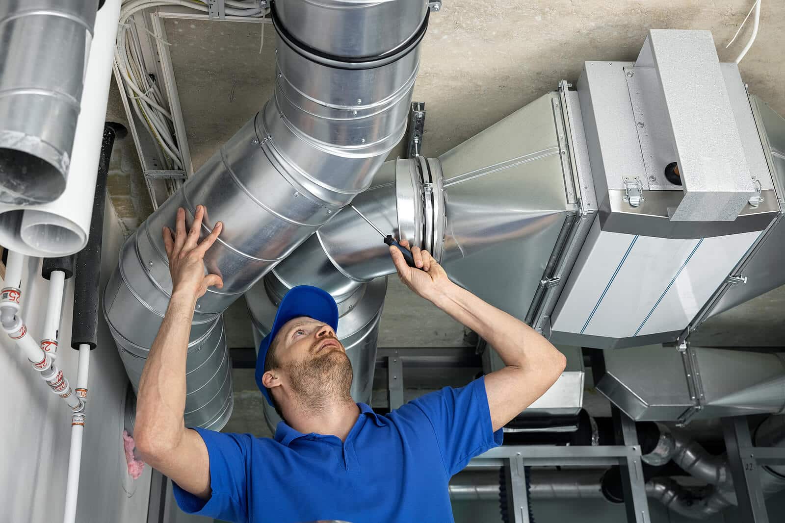 HVAC technician inspecting and repairing air ducts in San Clemente