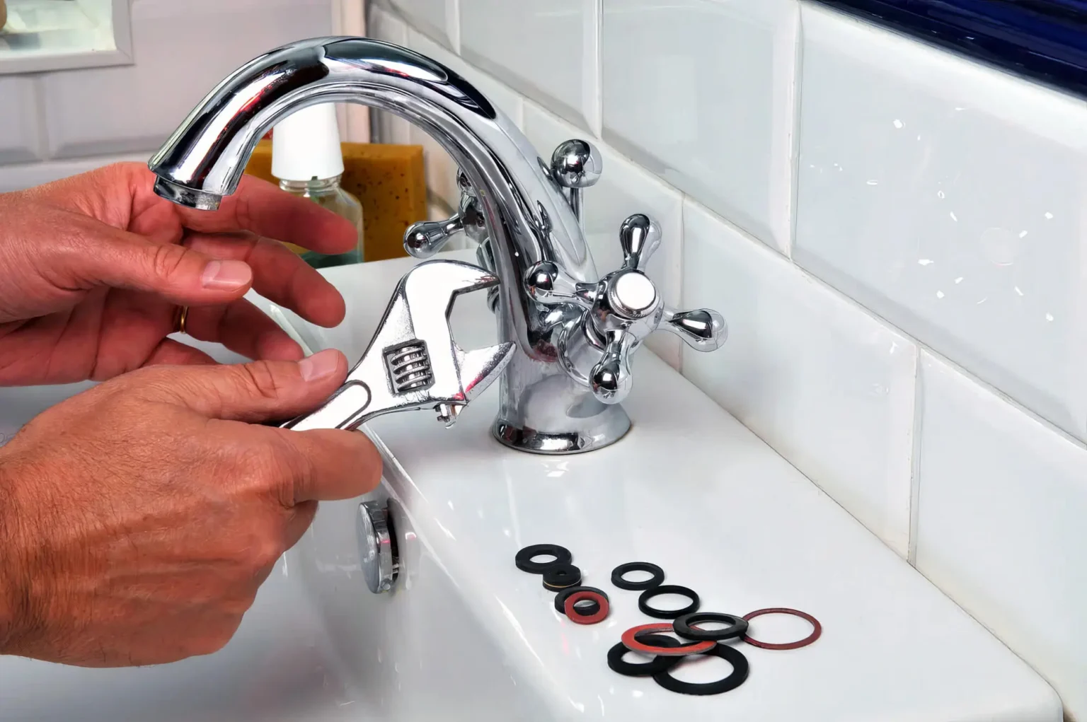 Plumber maintaining a bathroom faucet in San Clemente