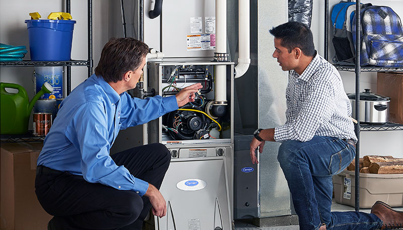 Technician evaluating a furnace for repair or replacement in San Clemente