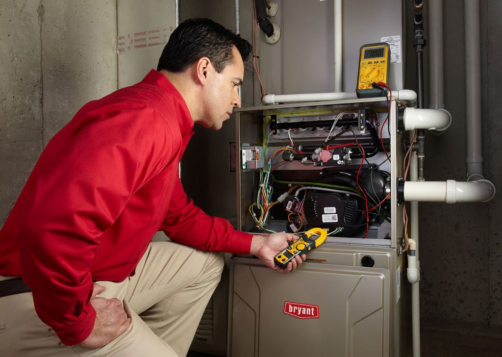 Heating technician diagnosing a furnace repair in San Clemente