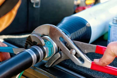 Technician repairing an industrial pipe connection in San Clemente
