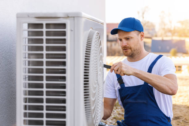 HVAC technician servicing an outdoor air conditioner in San Clemente
