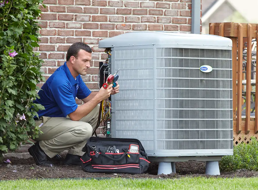 HVAC technician inspecting an outdoor AC unit in San Clemente